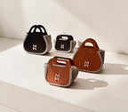 Makafui Adom collection featuring luxury handmade crochet handbags with structured wooden frames in beige.
